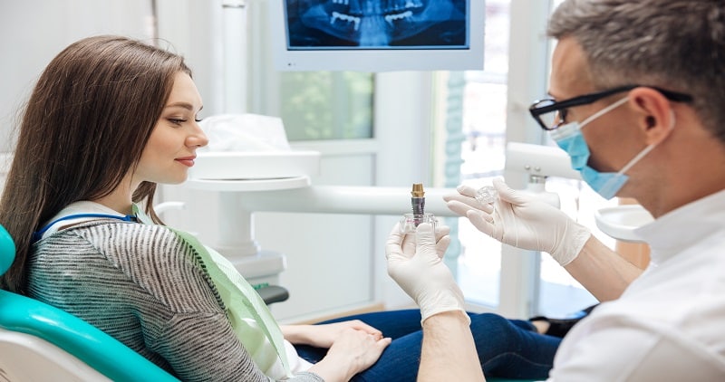 dentist showing a dental implant